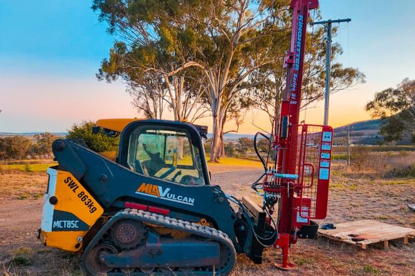 Kinghitter Series 2i post driver on skidsteer with auger and safety system in Australia