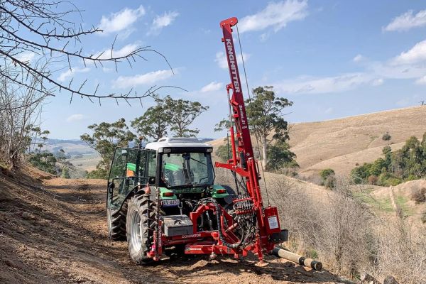 Australian fencing contractor using Kinghitter Series 2i 450 post driver with Dominator Rotational Base on farm fence build.